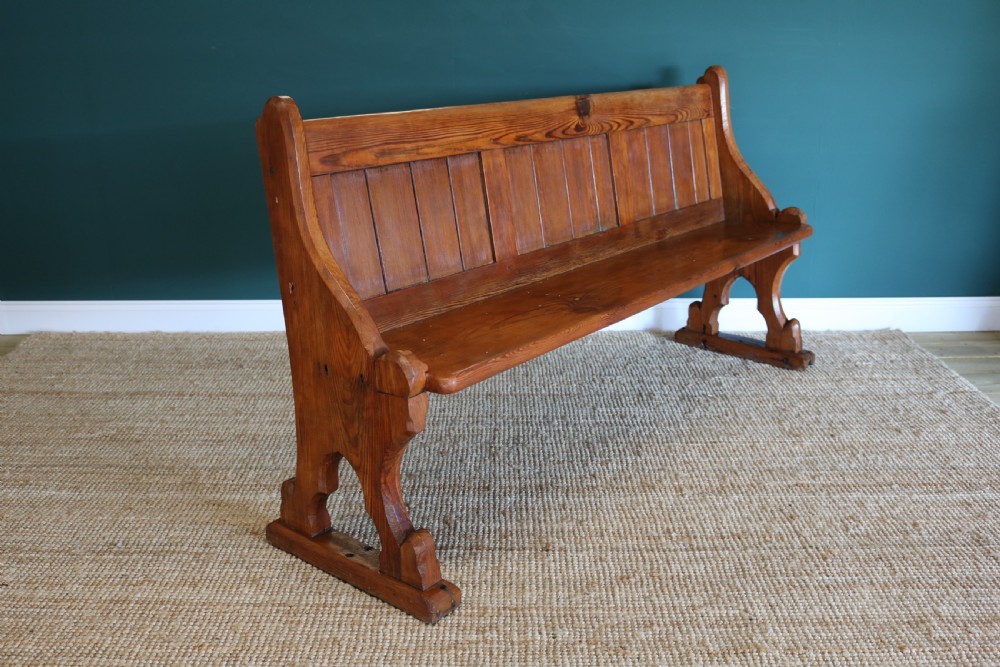 A Gothic Revival-style pine pew
