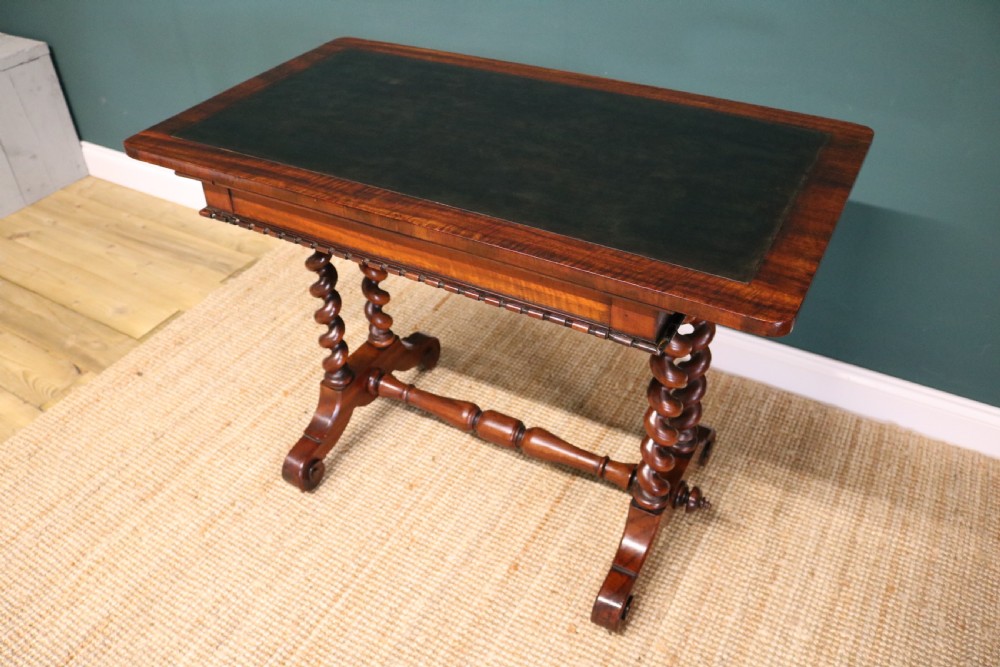 A William IV Goncalo Alves writing table featuring a dark green leather inset top, twin barley twist leg supports, and a central turned stretcher. View V