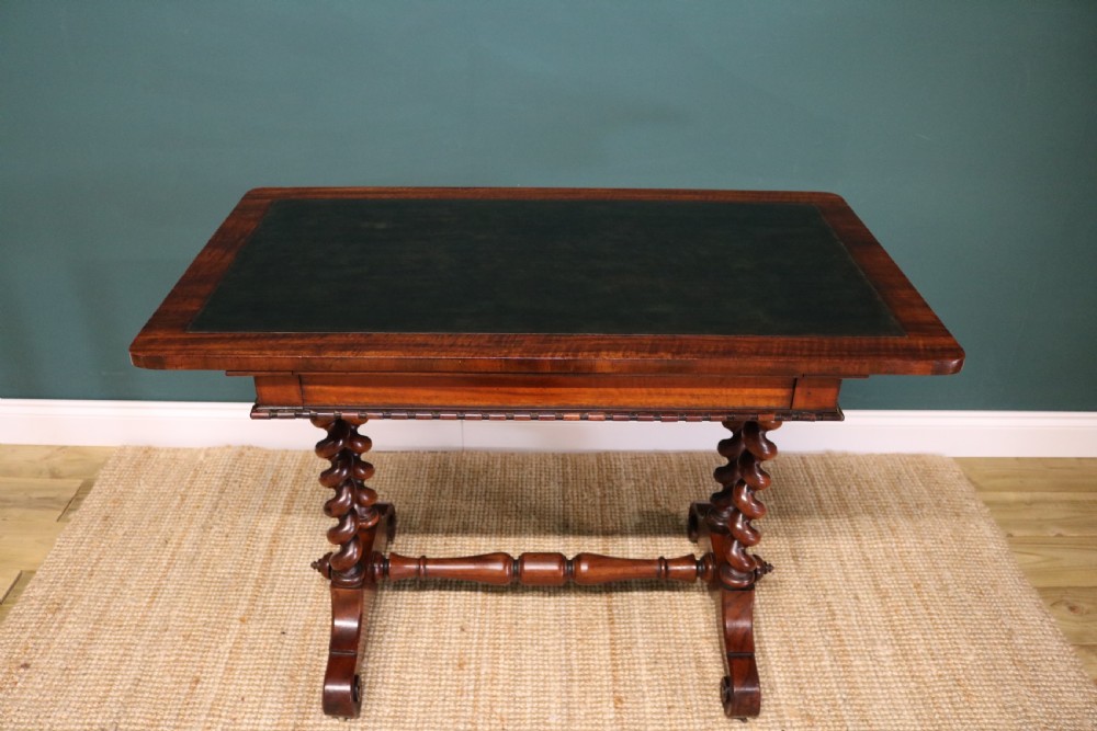 A William IV Goncalo Alves writing table featuring a dark green leather inset top, twin barley twist leg supports, and a central turned stretcher. View VIII