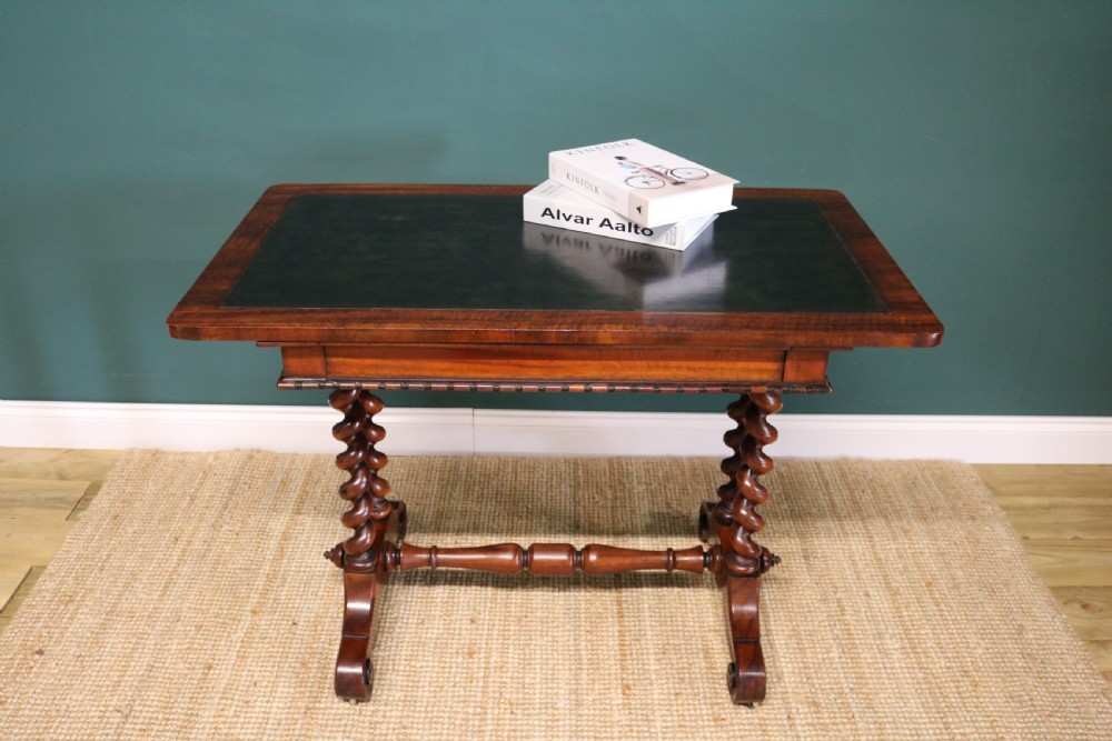 A William IV Goncalo Alves writing table featuring a dark green leather inset top, twin barley twist leg supports, and a central turned stretcher. View XIII