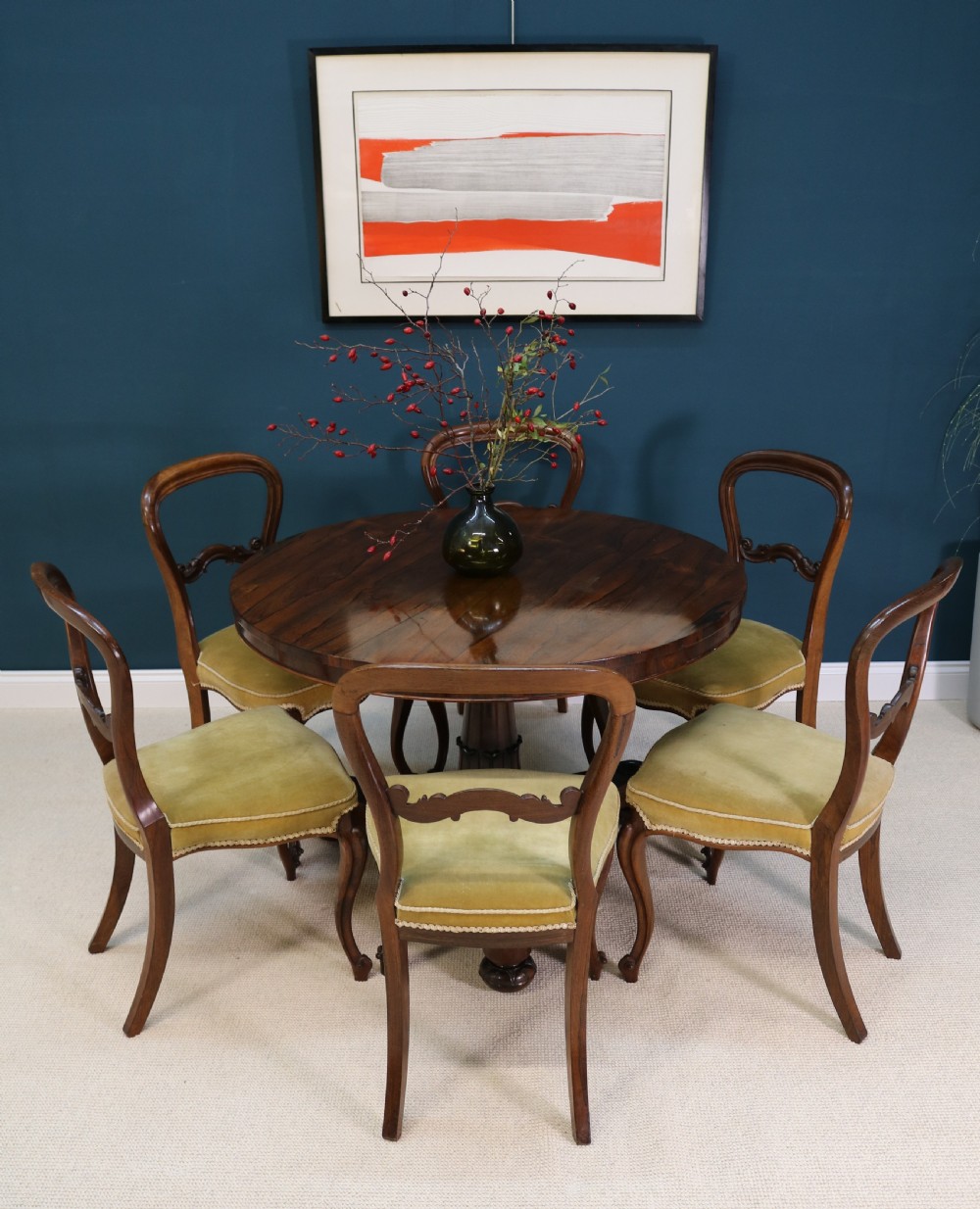 A circular 19th-century William IV rosewood centre table featuring a turned central column on a triform plinth base with carved feet. View X