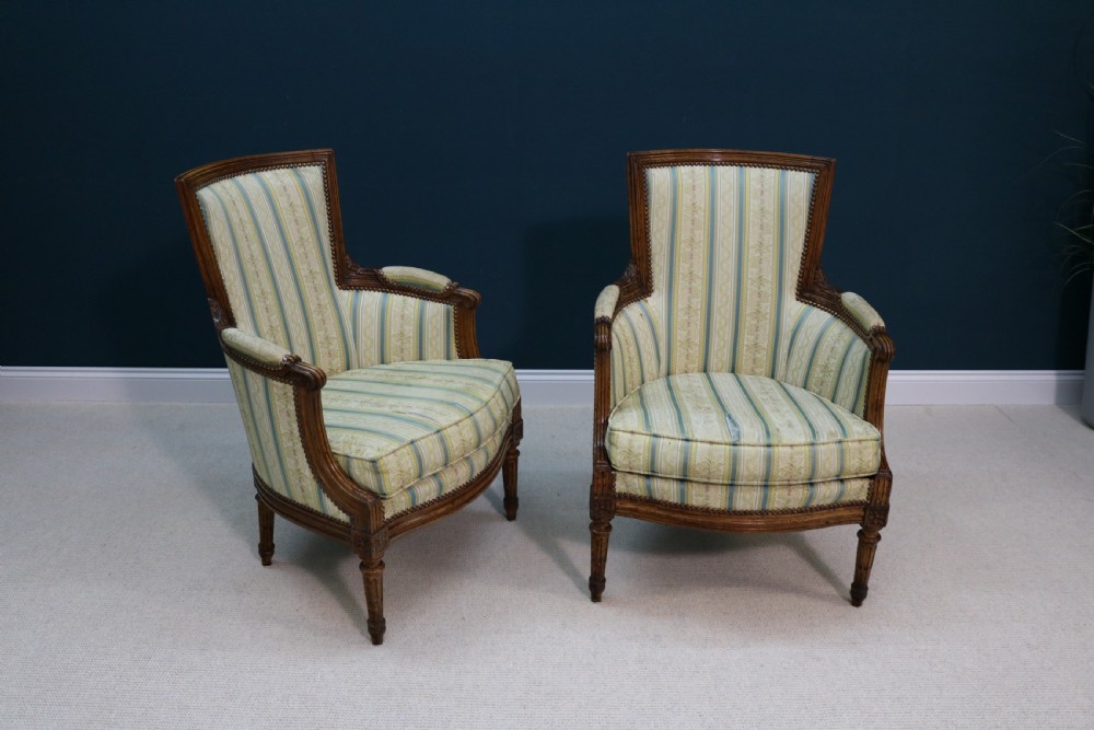 A pair of walnut fauteuil armchairs in French Louis XVI taste View II