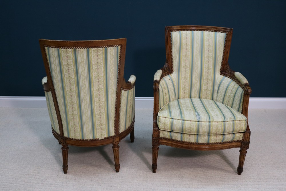 A pair of walnut fauteuil armchairs in French Louis XVI taste View III