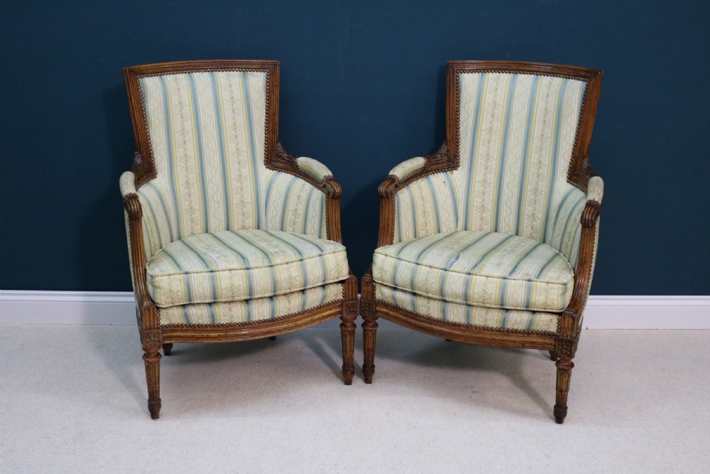 A pair of walnut fauteuil armchairs in French Louis XVI taste View IV