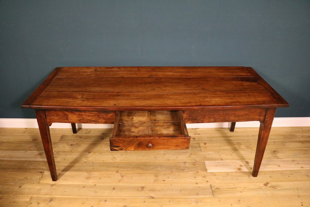 An antique French fruitwood farmhouse table featuring a rectangular plank top, a single frieze drawer with a wooden knob, and square tapered legs. View III