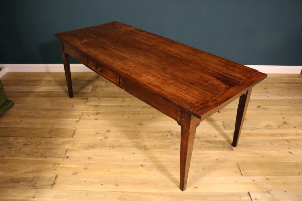 An antique French fruitwood farmhouse table featuring a rectangular plank top, a single frieze drawer with a wooden knob, and square tapered legs. View V