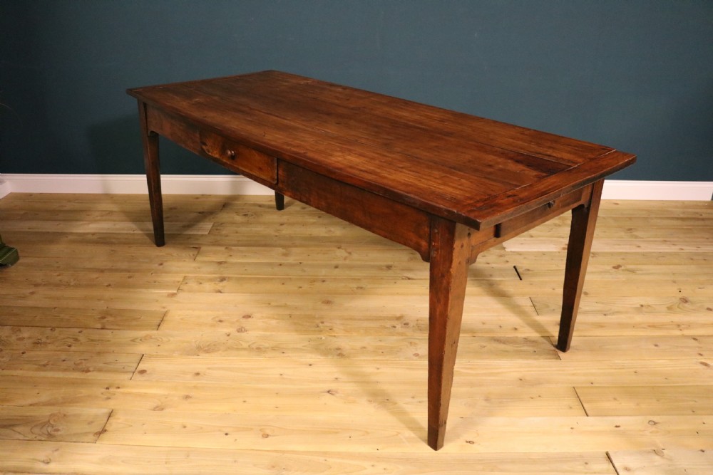An antique French fruitwood farmhouse table featuring a rectangular plank top, a single frieze drawer with a wooden knob, and square tapered legs. View VI