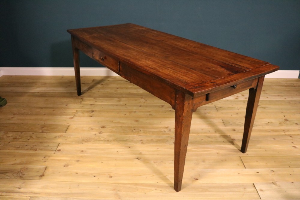 An antique French fruitwood farmhouse table featuring a rectangular plank top, a single frieze drawer with a wooden knob, and square tapered legs. View VIII