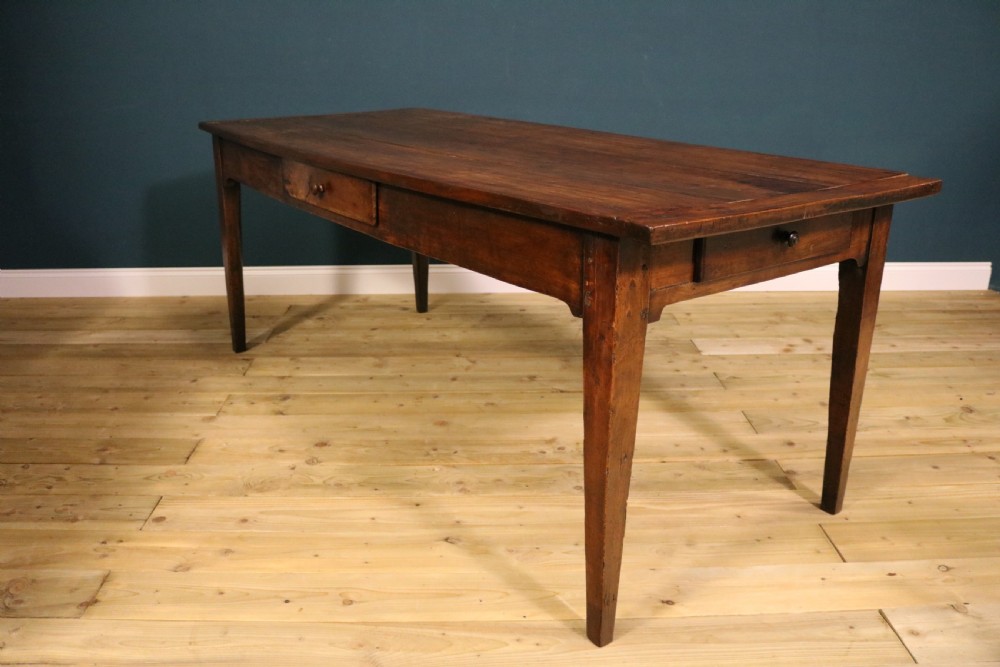 An antique French fruitwood farmhouse table featuring a rectangular plank top, a single frieze drawer with a wooden knob, and square tapered legs. View IX
