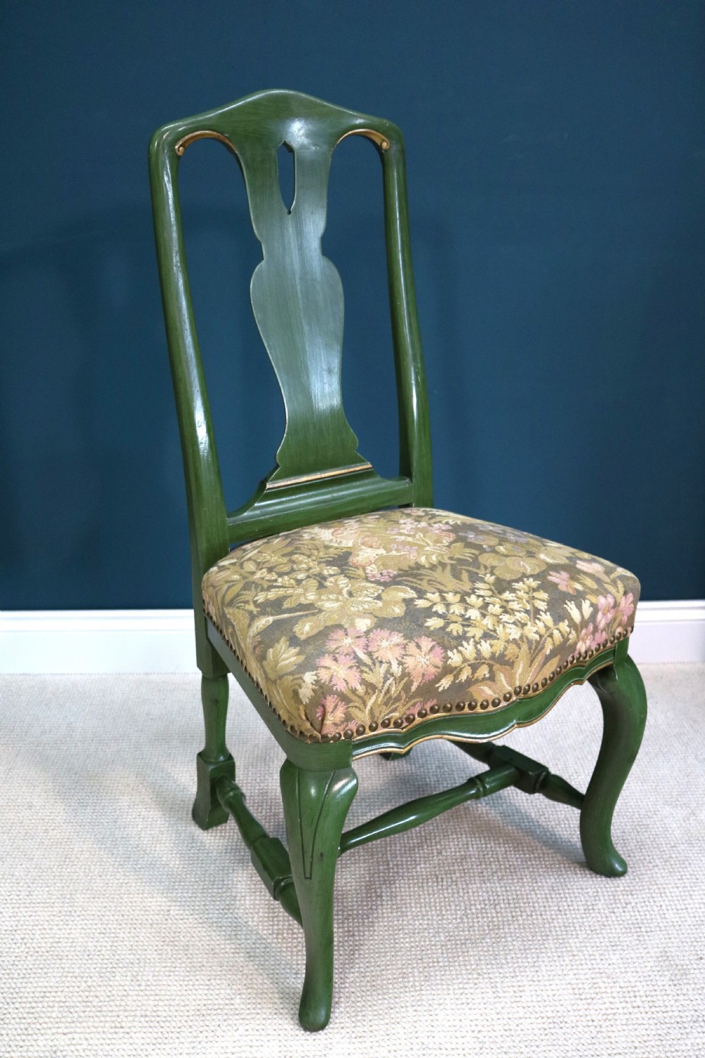 A green painted secretaire writing cabinet featuring an arched glazed upper display section, a fall-front desk revealing fitted compartments, three lower drawers with brass handles, and a matching upholstered chair. View IX