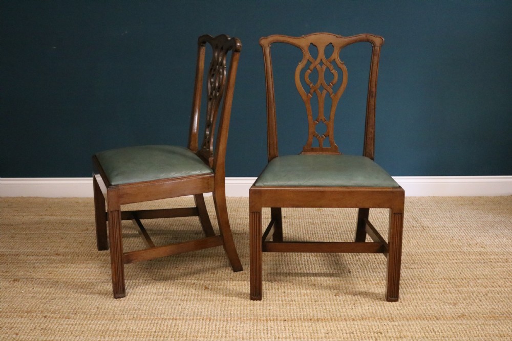 A set of six George III style mahogany dining chairs with carved pierced back splats and green leather drop-in seats. View IV