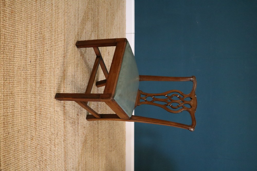 A set of six George III style mahogany dining chairs with carved pierced back splats and green leather drop-in seats. View VIII