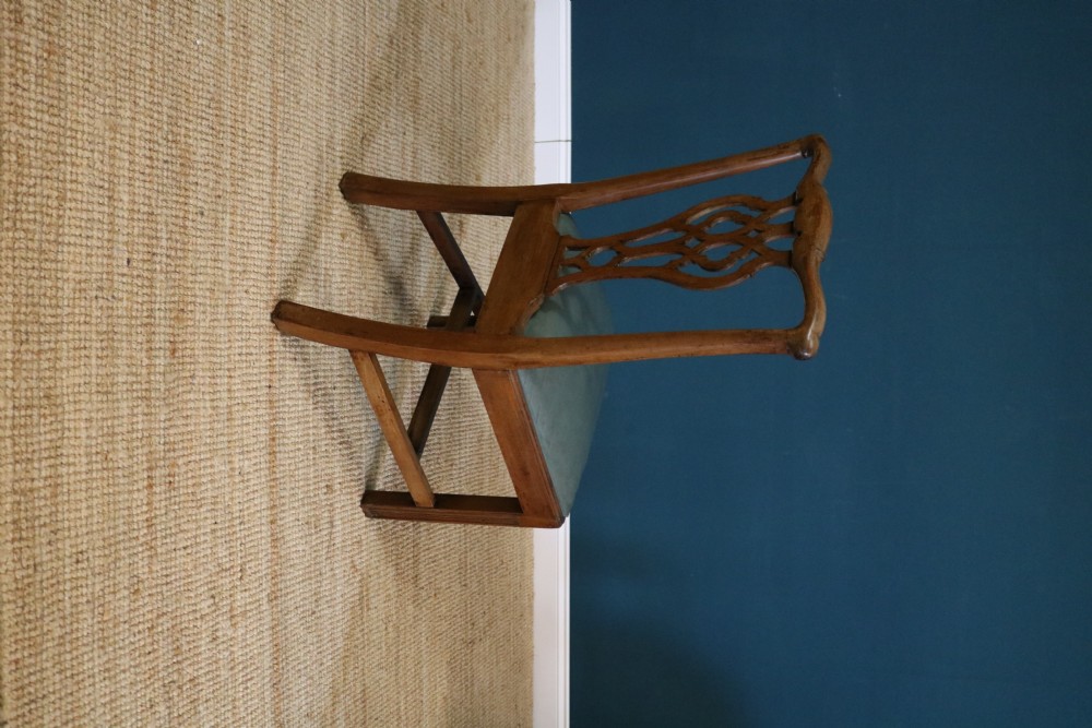 A set of six George III style mahogany dining chairs with carved pierced back splats and green leather drop-in seats. View IX