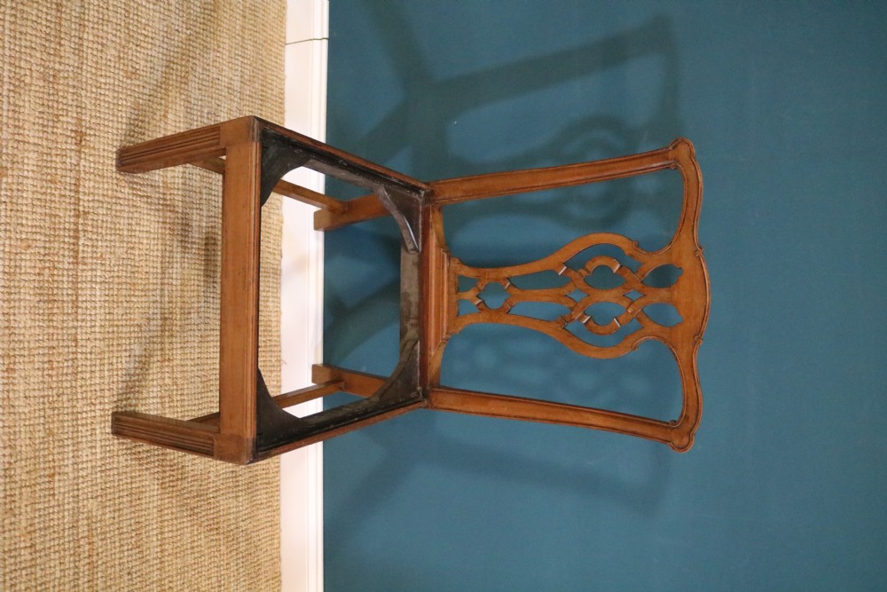 A set of six George III style mahogany dining chairs with carved pierced back splats and green leather drop-in seats. View X