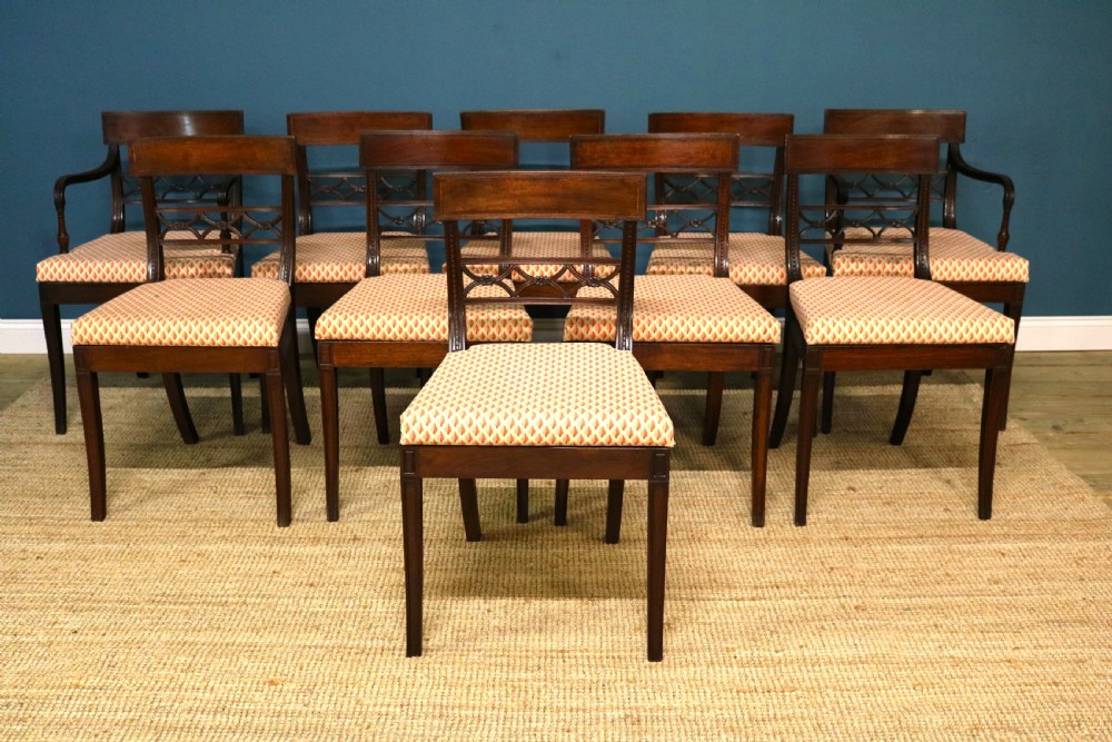 A set of ten Regency style mahogany dining chairs featuring hand-woven cane seats, tablet top rails, geometric carved splats, and two matching carver armchairs. View III