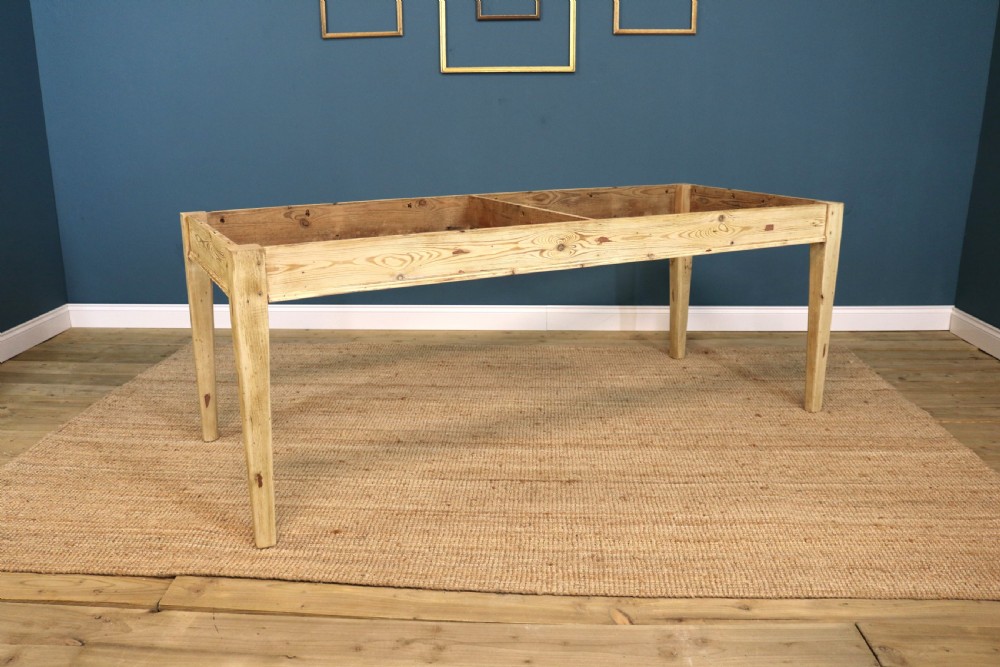 A long rectangular bleached pine dining table supported by four square tapered legs and a simple straight apron. View VI