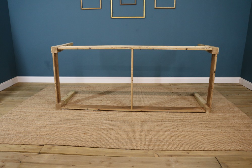 A long rectangular bleached pine dining table supported by four square tapered legs and a simple straight apron. View VII
