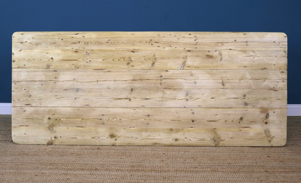A long rectangular bleached pine dining table supported by four square tapered legs and a simple straight apron. View VIII
