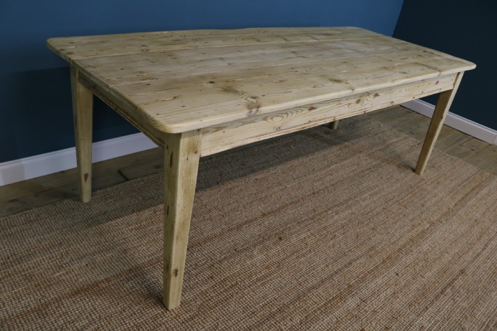 A long rectangular bleached pine dining table supported by four square tapered legs and a simple straight apron. View XI