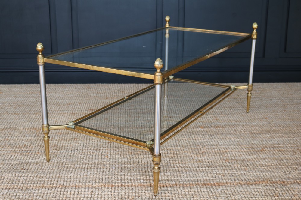 A two-tier rectangular brass and glass coffee table featuring finial corner posts and tapered legs. View VI