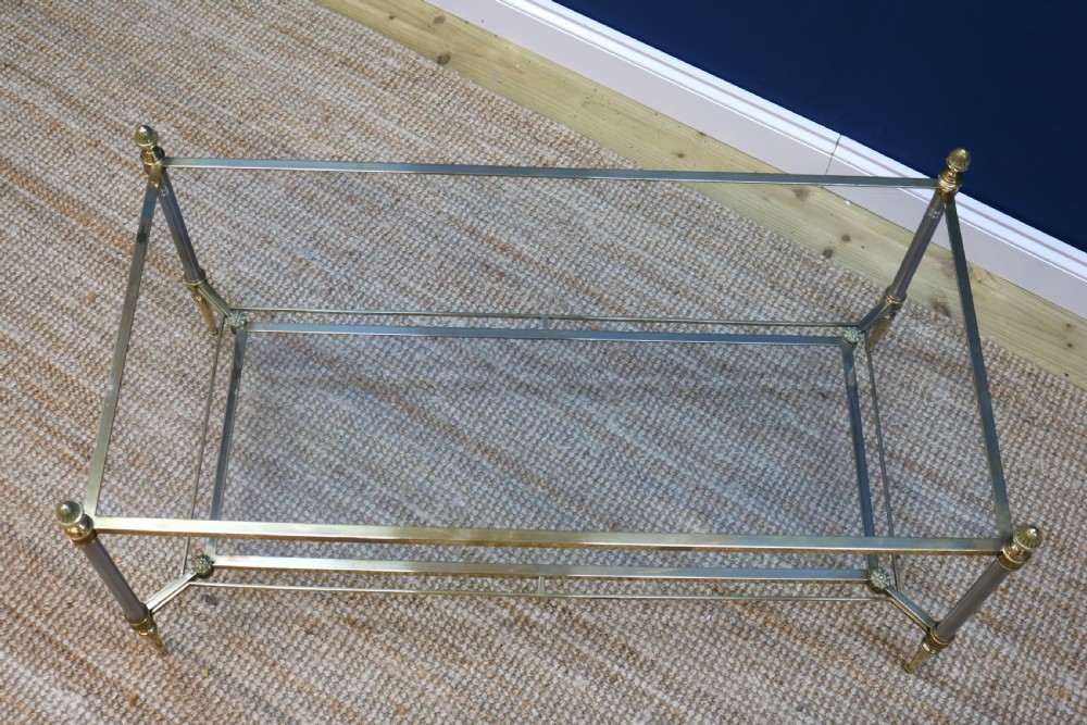 A two-tier rectangular brass and glass coffee table featuring finial corner posts and tapered legs. View VII
