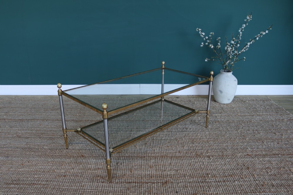 A two-tier rectangular brass and glass coffee table featuring finial corner posts and tapered legs. View VIII