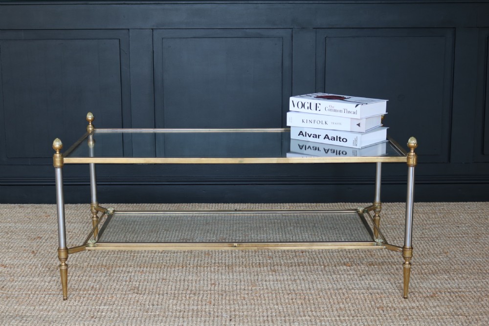 A two-tier rectangular brass and glass coffee table featuring finial corner posts and tapered legs. View IX