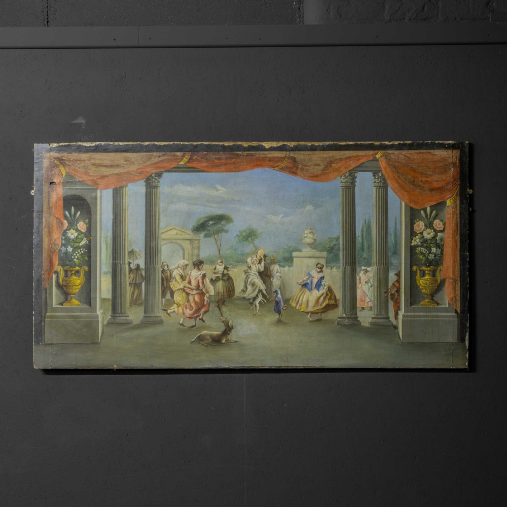 A horizontal late Victorian oil painting depicting a theatrical stage with classical fluted columns, draped terracotta curtains, and costumed figures in an outdoor courtyard.