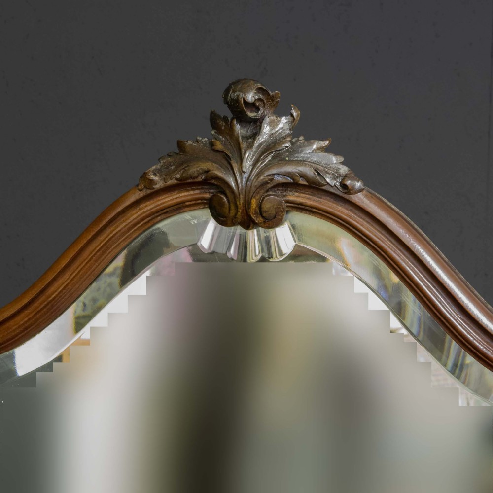 A Victorian carved mahogany dressing table featuring a central swing mirror, small upper jewellery drawers, lower storage drawers, and carved cabriole legs. View III