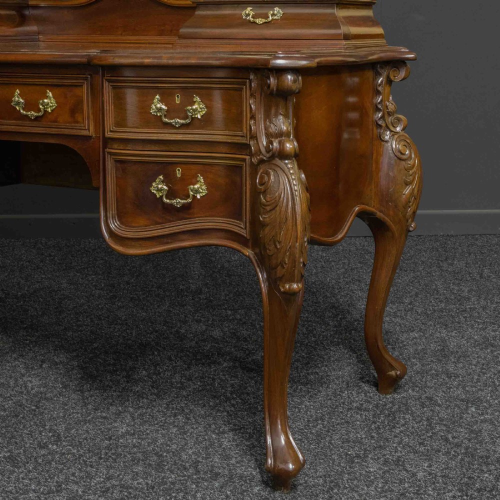 A Victorian carved mahogany dressing table featuring a central swing mirror, small upper jewellery drawers, lower storage drawers, and carved cabriole legs. View VIII