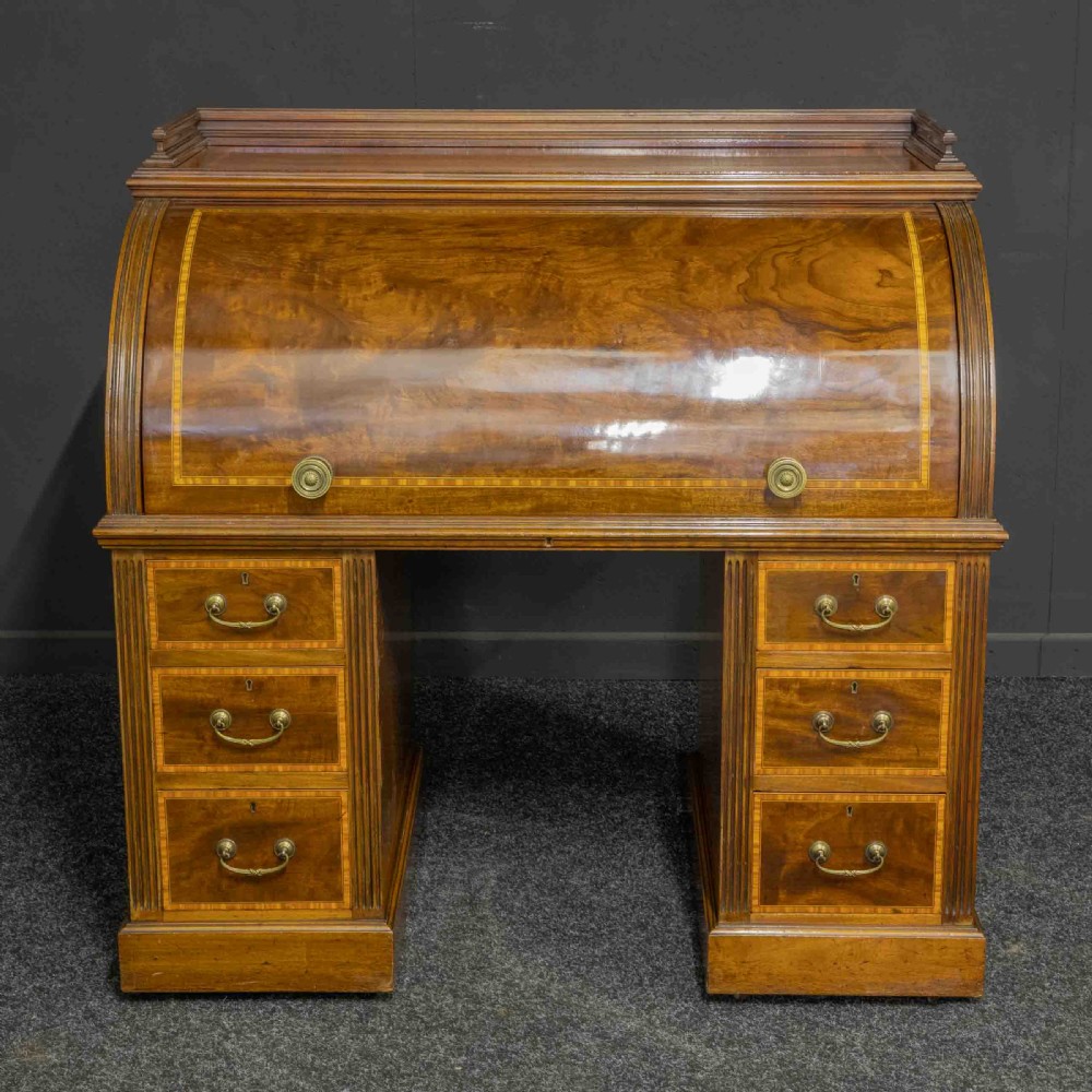 A Sheraton Revival mahogany cylinder desk featuring satinwood crossbanding, twin drawer pedestals, and an extended writing surface fitted with blue leather. View III