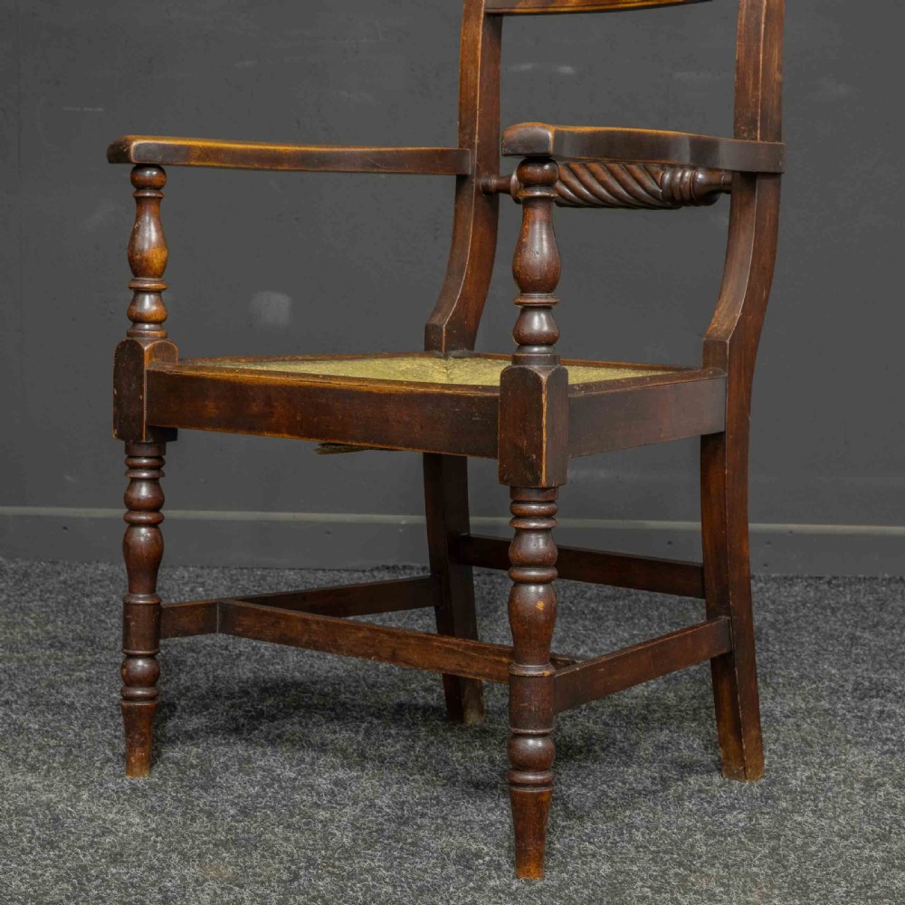 A dark timber provincial Regency armchair featuring a woven rush seat, turned legs, curved arms, and a rope twist back splat. View VII