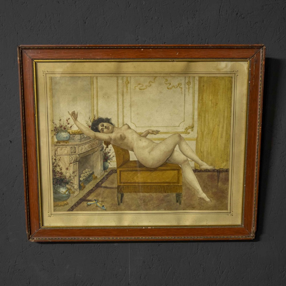 A 19th-century framed watercolour painting depicting a reclining female nude figure on an ochre bench inside an ornate interior with a fireplace.