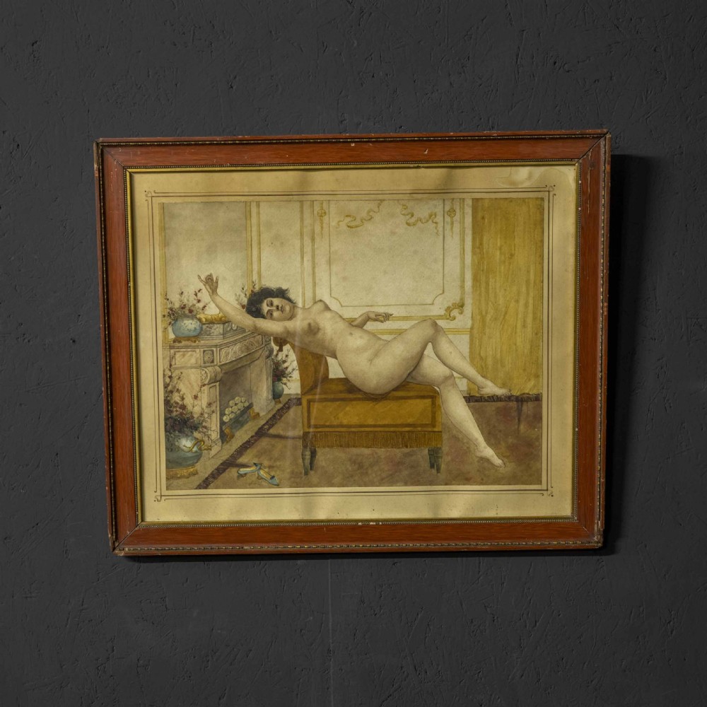 A 19th-century framed watercolour painting depicting a reclining female nude figure on an ochre bench inside an ornate interior with a fireplace. View II