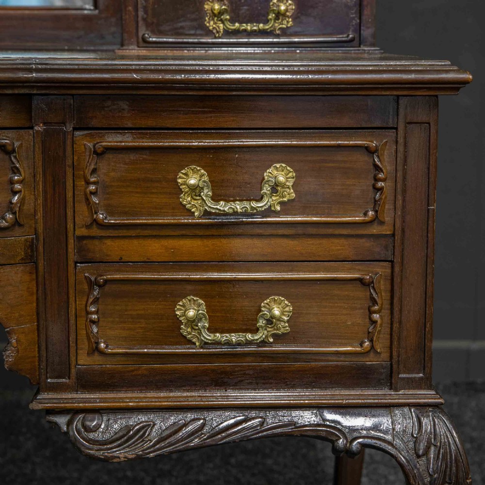 A late Victorian dark mahogany ladies writing desk featuring a green leather inset top, raised mirror superstructure, small side drawers, carved cabriole legs, and brass handles. View XI