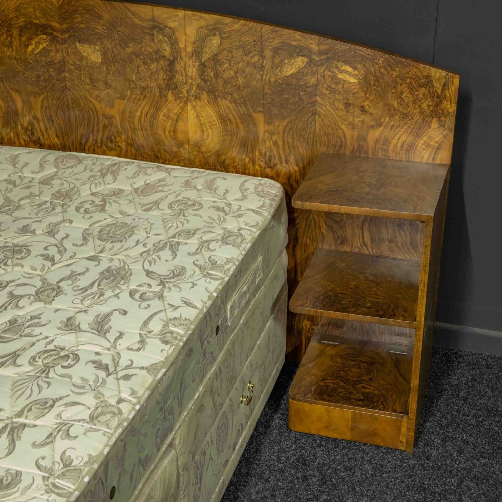 An Art Deco burr walnut headboard featuring a gently arched crest and integrated open bedside shelves on both sides. View II
