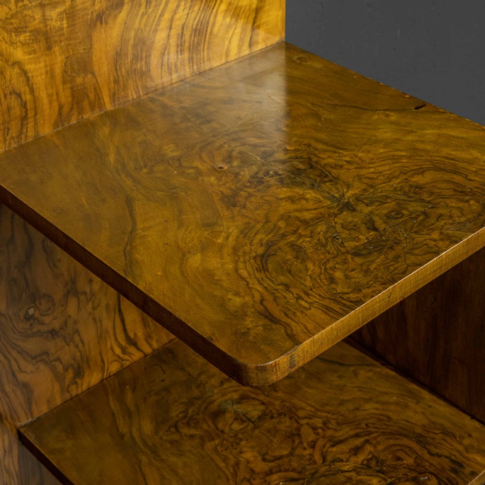 An Art Deco burr walnut headboard featuring a gently arched crest and integrated open bedside shelves on both sides. View VIII