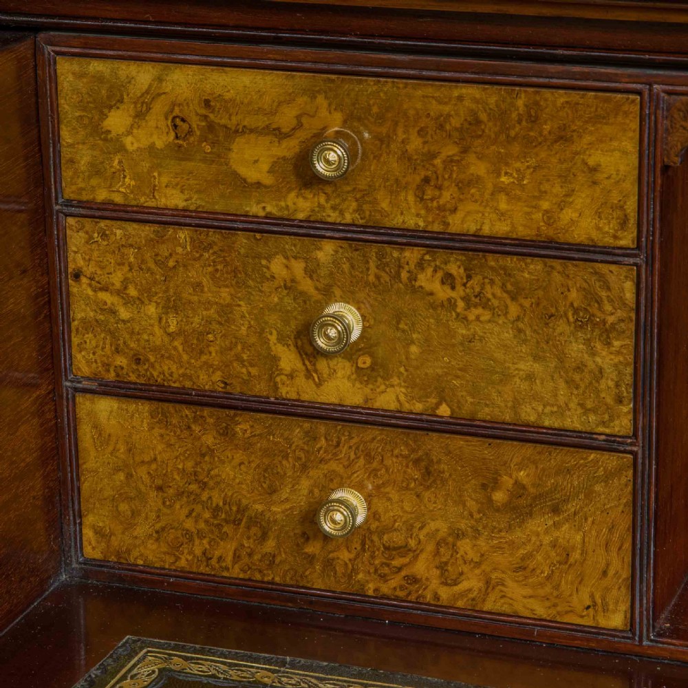 A tall Victorian walnut secretaire bookcase featuring a glazed upper display section, a drop-down desk compartment, and carved double doors at the base with decorative brass mounts. View VIII