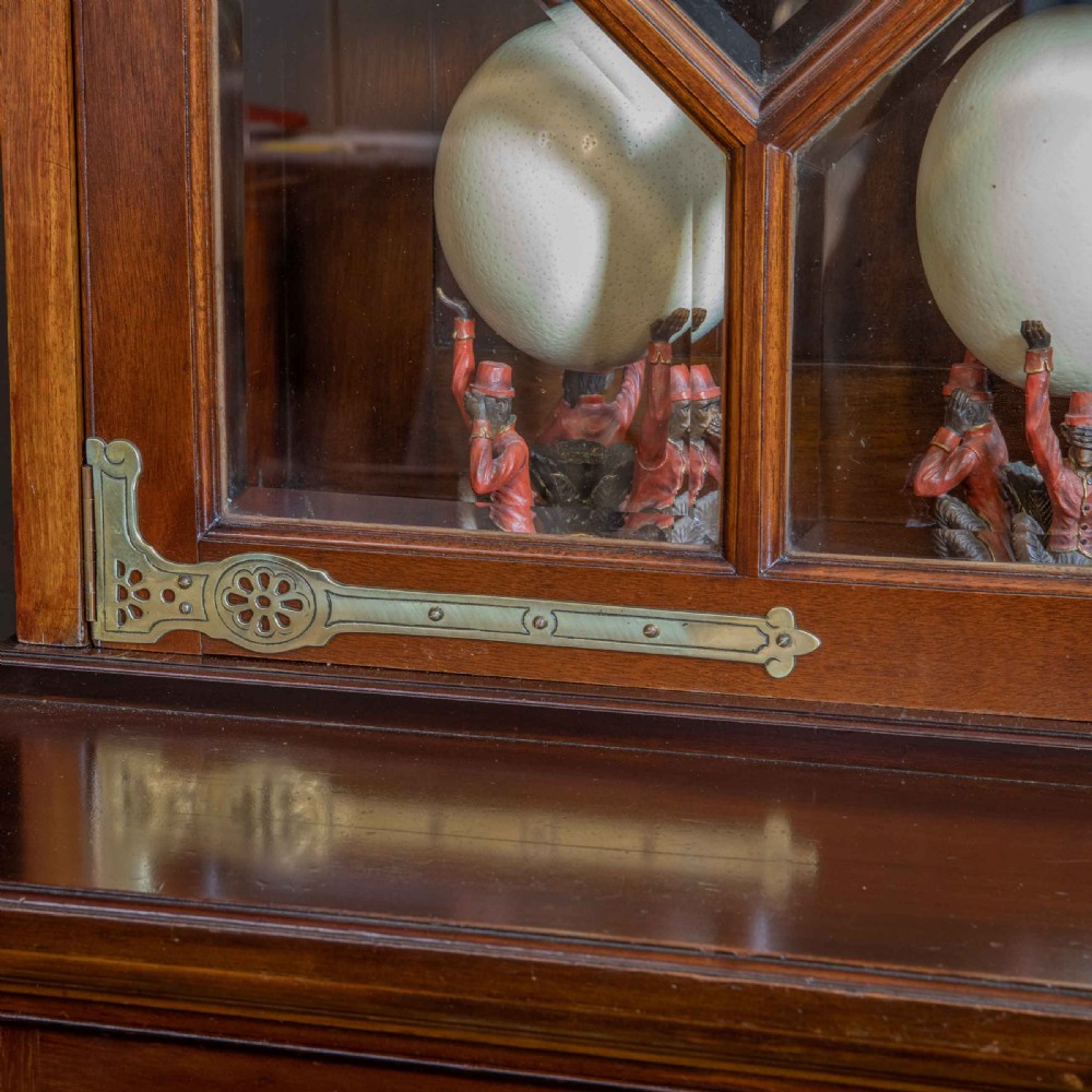 A tall Victorian walnut secretaire bookcase featuring a glazed upper display section, a drop-down desk compartment, and carved double doors at the base with decorative brass mounts. View XI