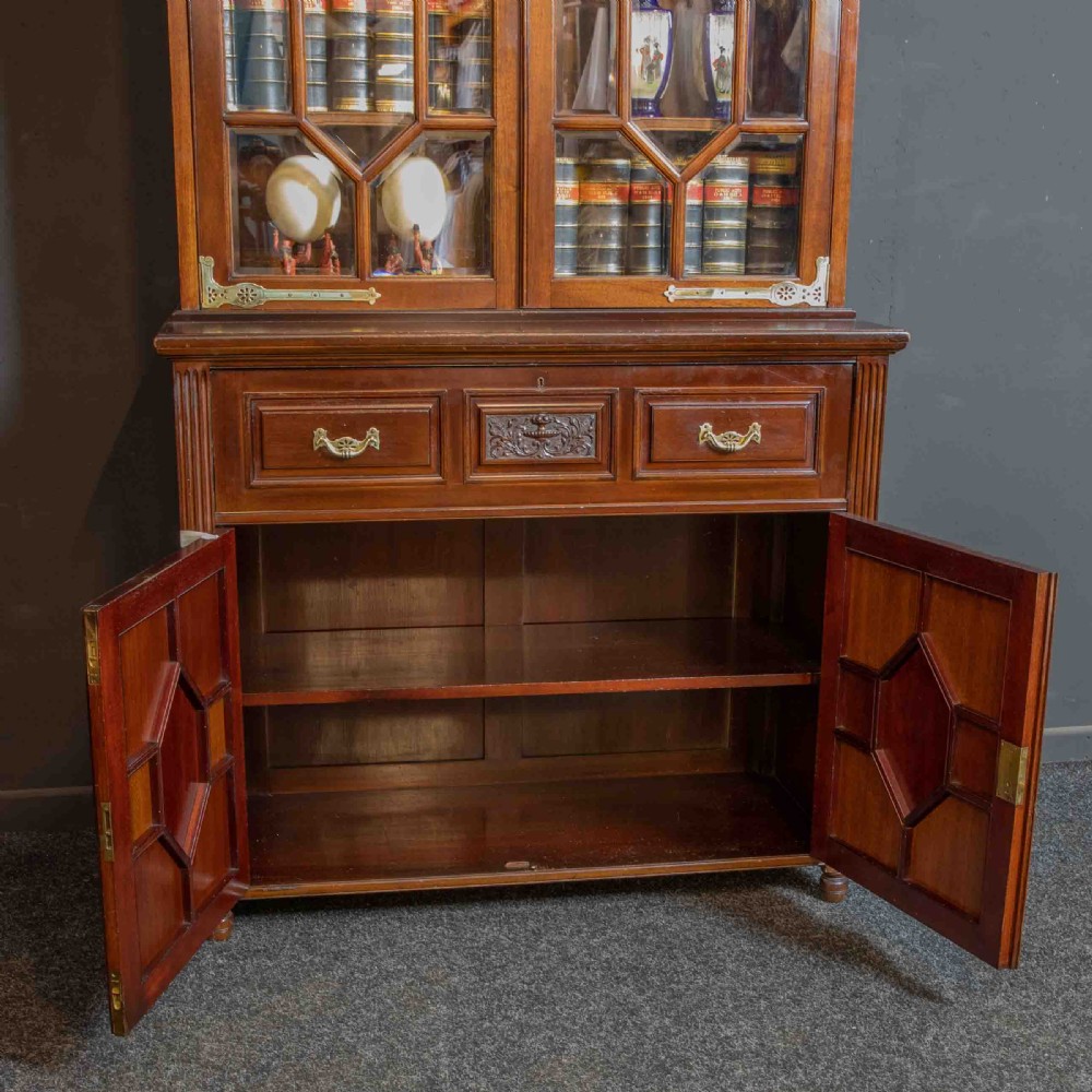 A tall Victorian walnut secretaire bookcase featuring a glazed upper display section, a drop-down desk compartment, and carved double doors at the base with decorative brass mounts. View XIV