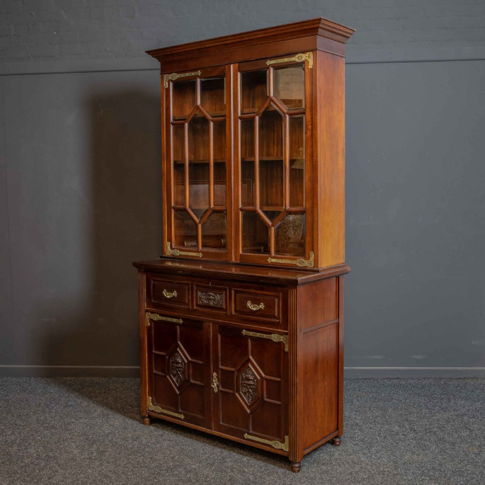 A tall Victorian walnut secretaire bookcase featuring a glazed upper display section, a drop-down desk compartment, and carved double doors at the base with decorative brass mounts. View XVIII