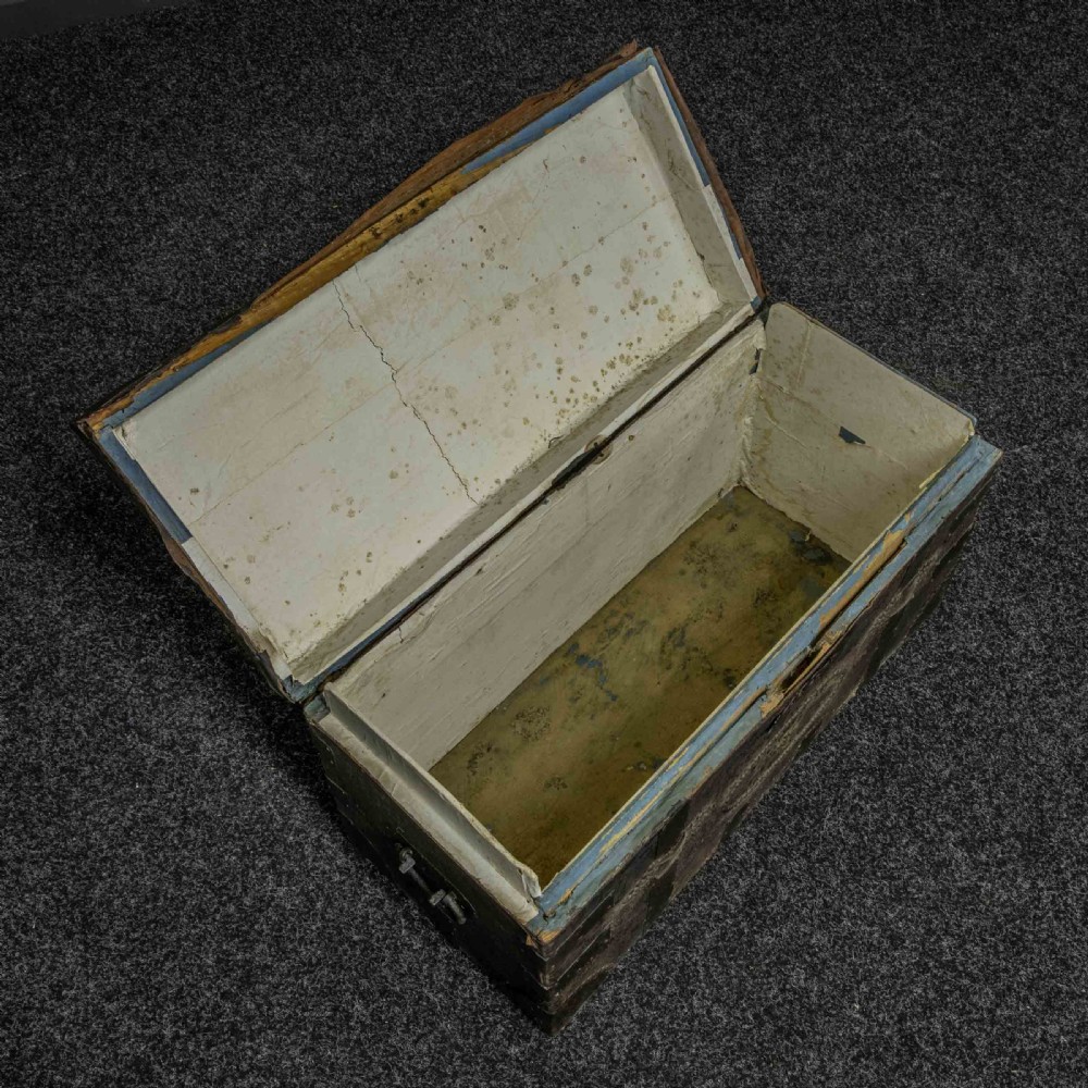 A rectangular Victorian trunk wrapped in dark brown leather with decorative brass studding, metal banding, and iron side handles. View II