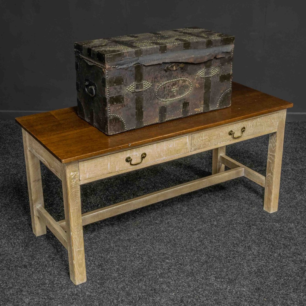 A rectangular Victorian trunk wrapped in dark brown leather with decorative brass studding, metal banding, and iron side handles. View VII
