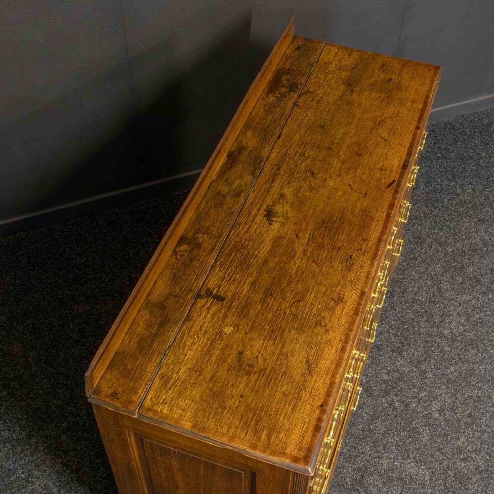 An 18th-century Georgian oak Lancashire mule chest with crossbanded drawer fronts, brass swan-neck handles, and bracket feet. View III
