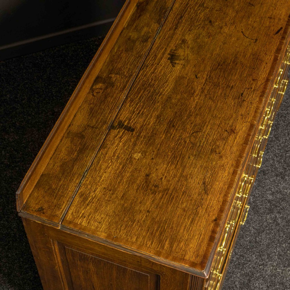 An 18th-century Georgian oak Lancashire mule chest with crossbanded drawer fronts, brass swan-neck handles, and bracket feet. View IV