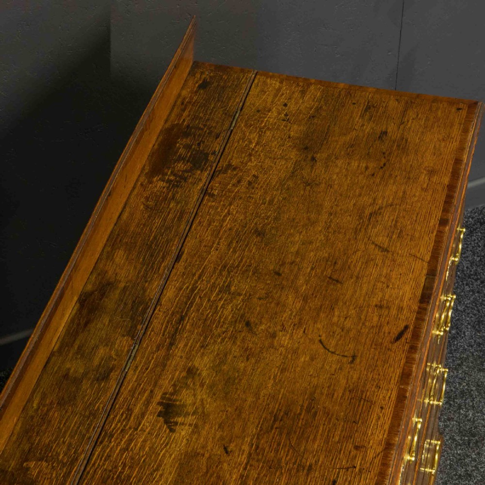 An 18th-century Georgian oak Lancashire mule chest with crossbanded drawer fronts, brass swan-neck handles, and bracket feet. View VIII