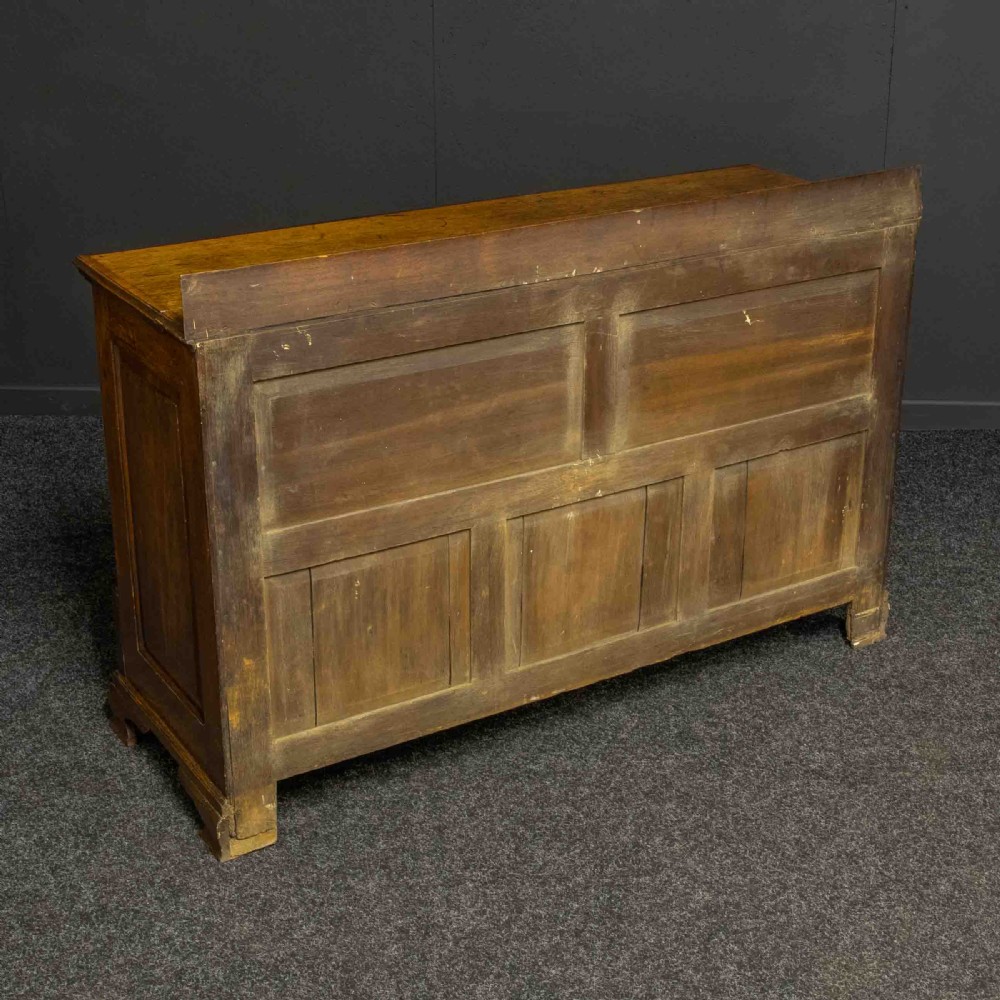 An 18th-century Georgian oak Lancashire mule chest with crossbanded drawer fronts, brass swan-neck handles, and bracket feet. View XIII