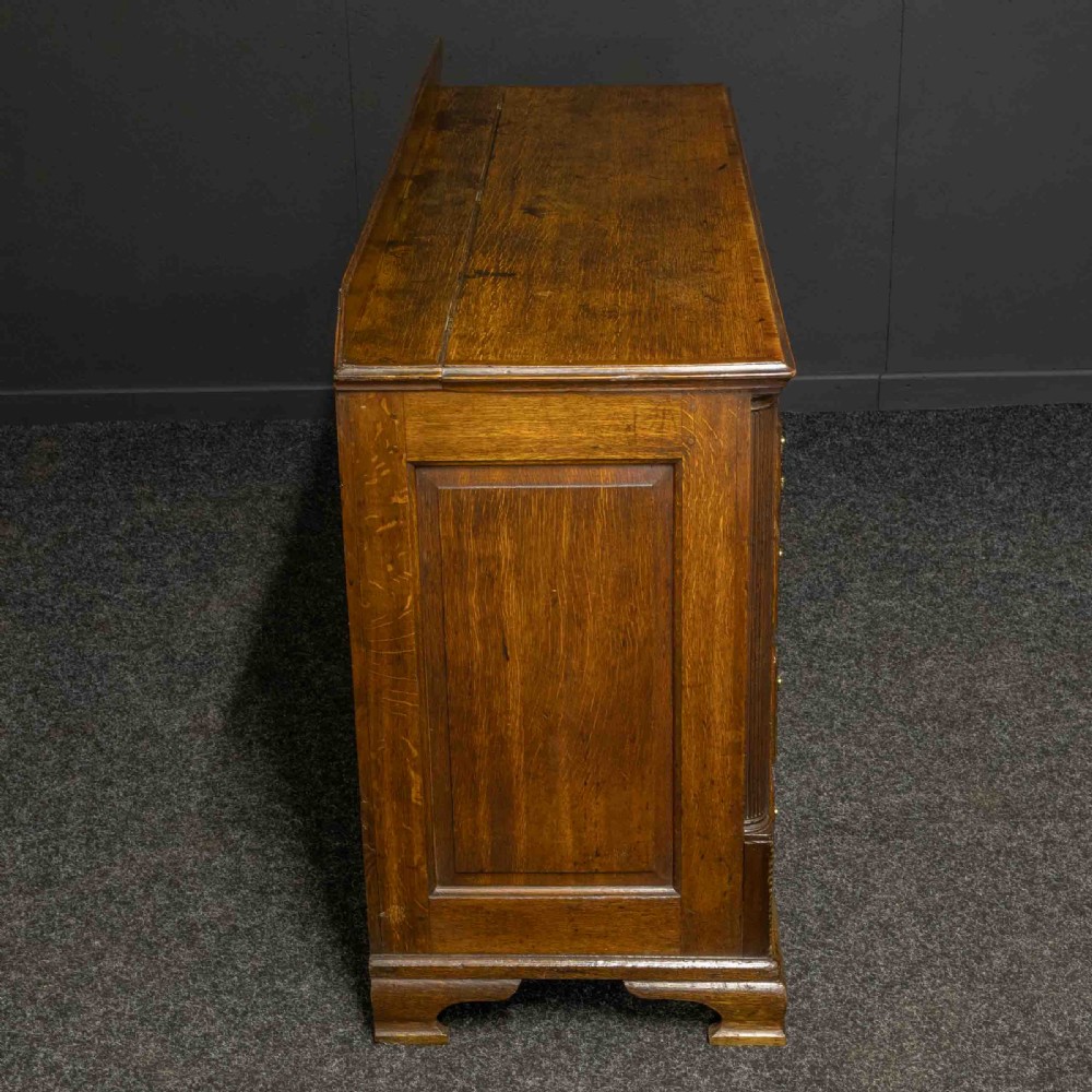 An 18th-century Georgian oak Lancashire mule chest with crossbanded drawer fronts, brass swan-neck handles, and bracket feet. View XIV