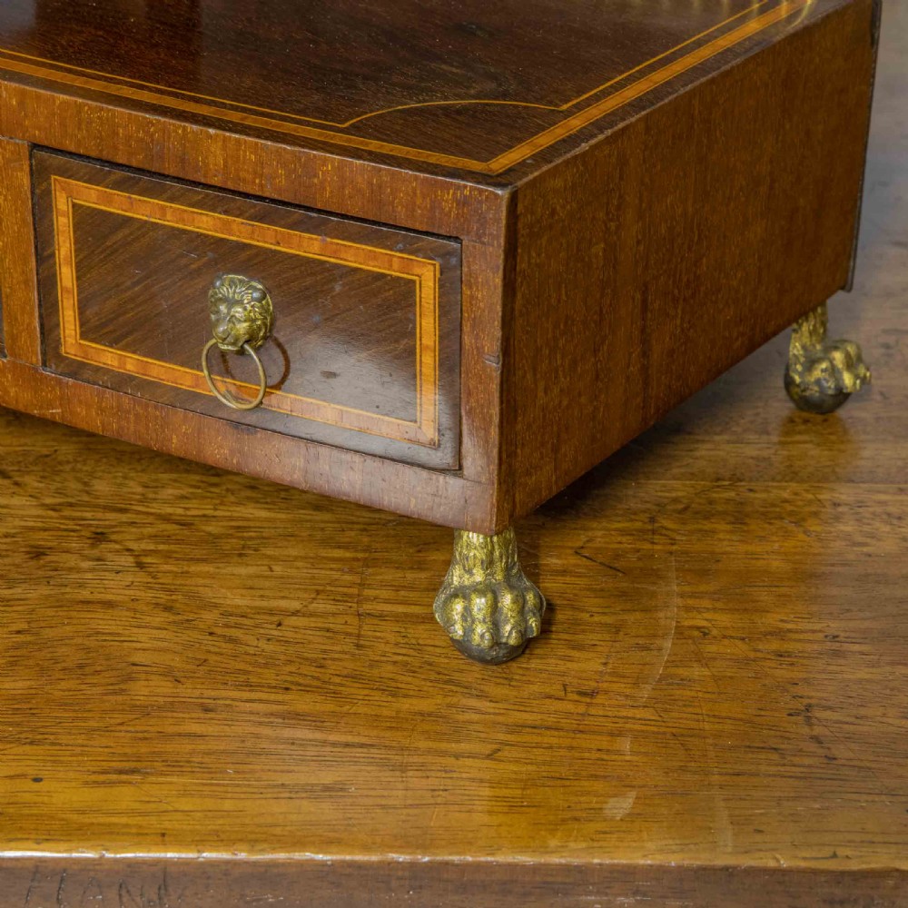 An Edwardian mahogany shield-shaped swing toilet mirror resting on a boxwood inlaid base with drawers and brass feet. View XI
