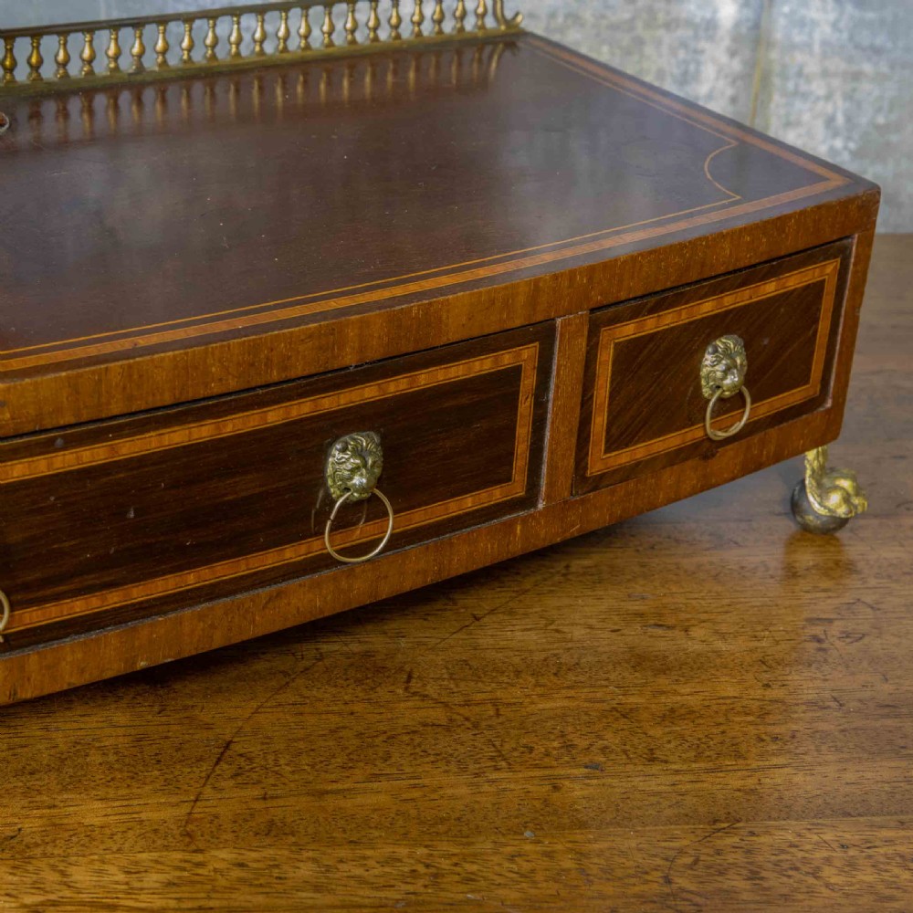 An Edwardian mahogany shield-shaped swing toilet mirror resting on a boxwood inlaid base with drawers and brass feet. View XIII